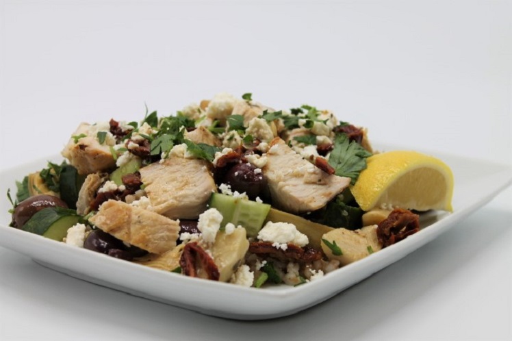 Grilled chicken breast on a farro grain salad with artichoke hearts, sun dried tomatoes, cucumbers, kalamata olives and feta cheese.