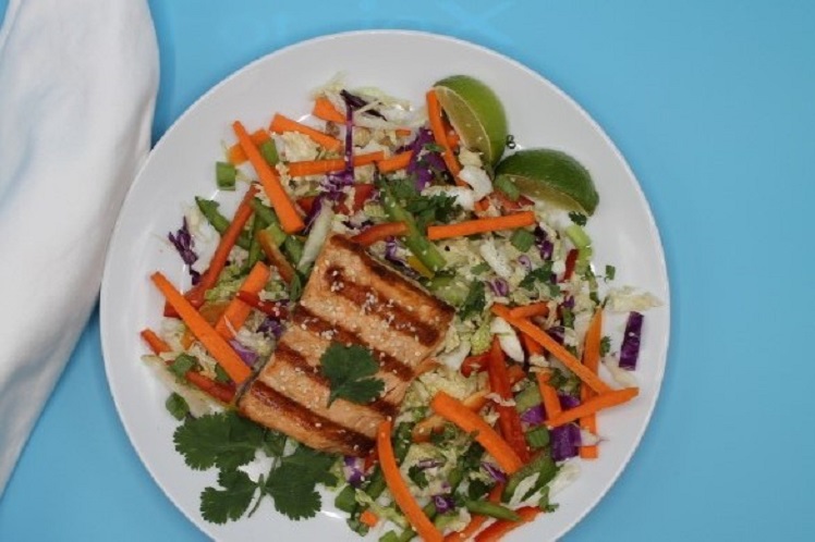 Grilled Thai salmon salad on Napa cabbage with bell peppers and honey sesame dressing.