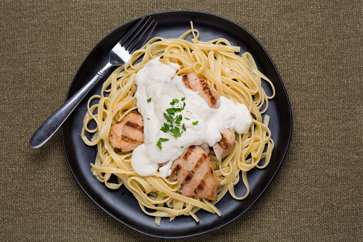 Fettuccine in creamy Alfredo sauce topped with sliced char grilled chicken breast.