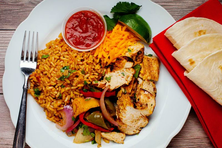 Chipotle chicken fajitas with grilled peppers and onions, Spanish rice, salsa and flour tortillas.