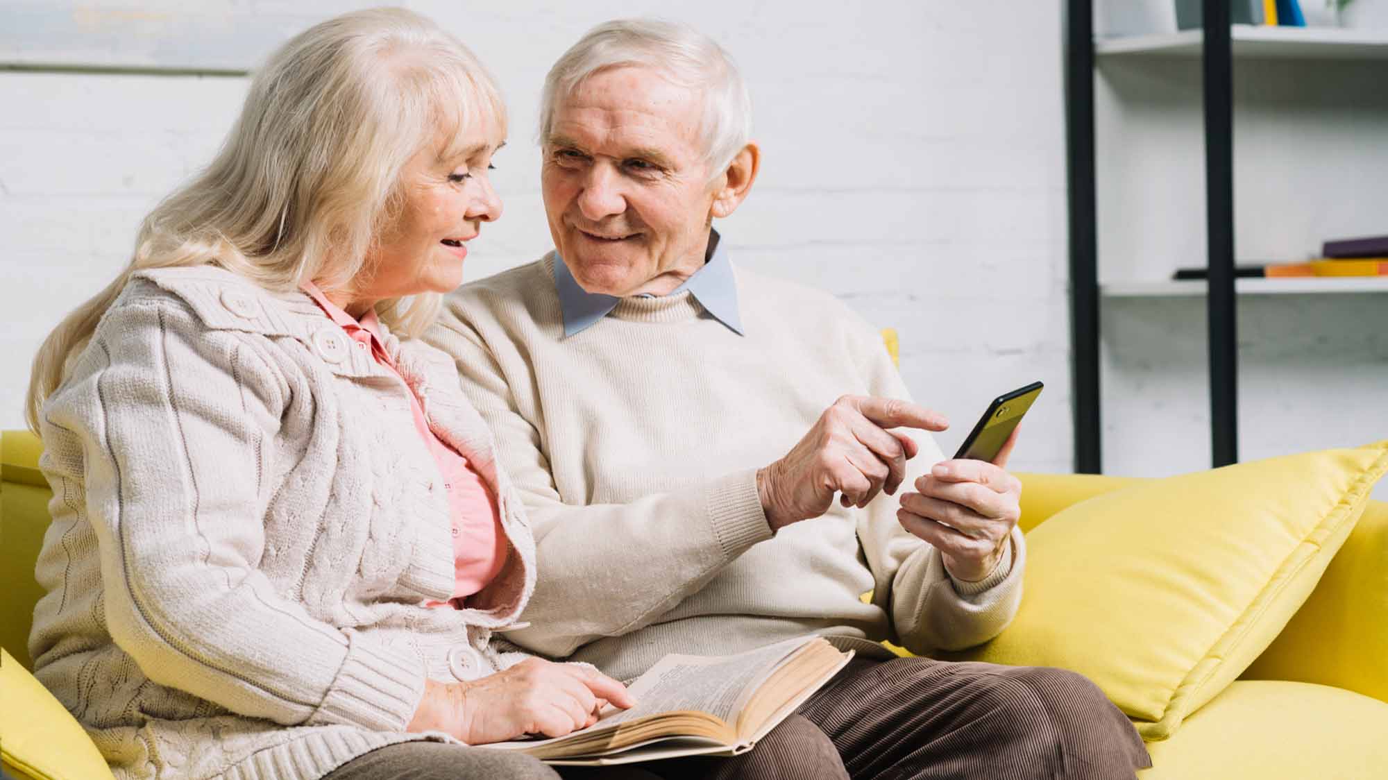 elderly-couple-using-app-on-smartphone