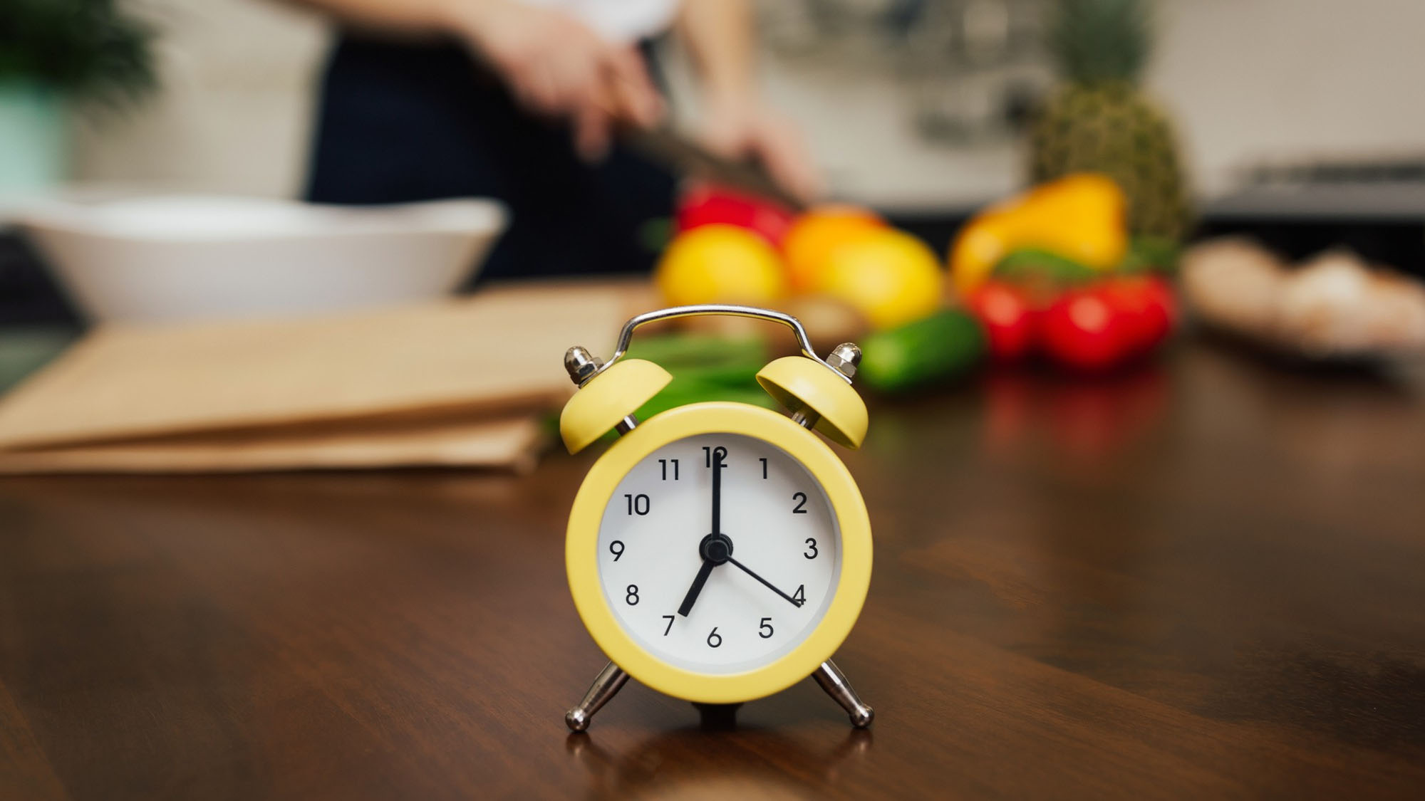 woman-saving-time-using-a-clock-while-preparing-meals